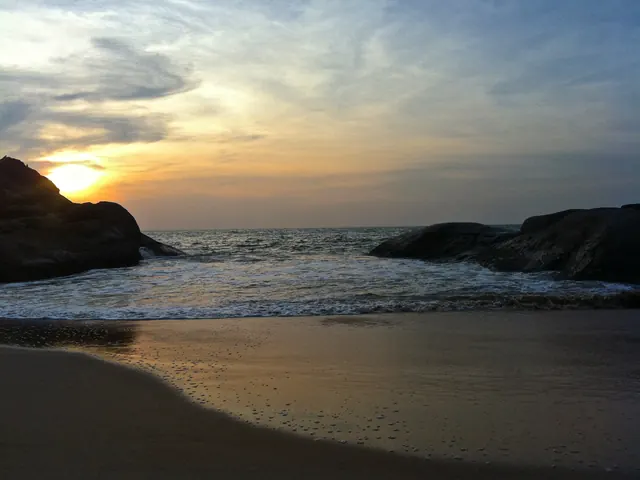 The sun setting behind rocks at Kapu beach