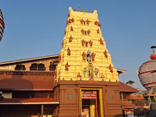The golden gopuram of the Krishna Temple at sunset