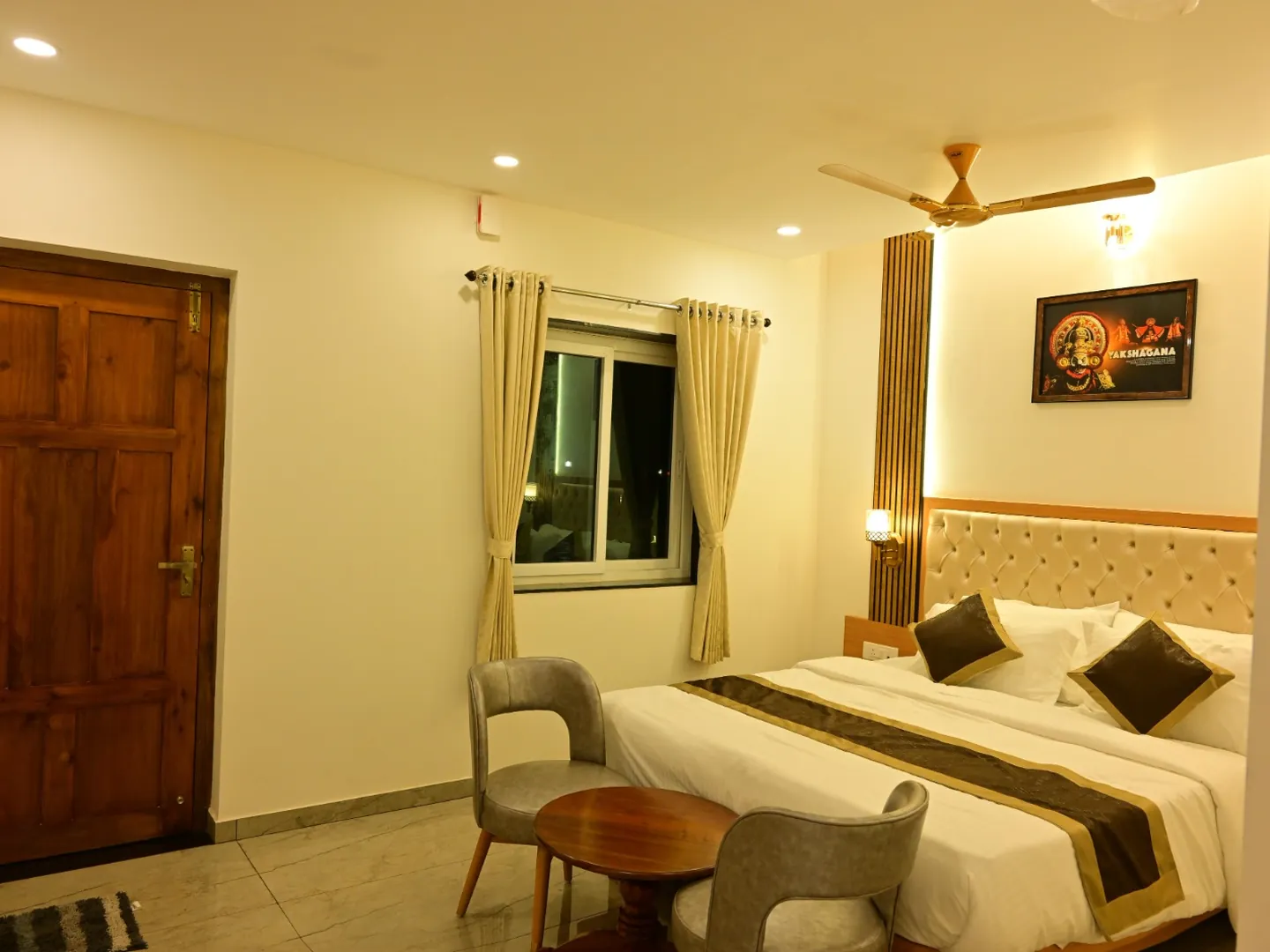 A room with a double bed, a window and a seating corner