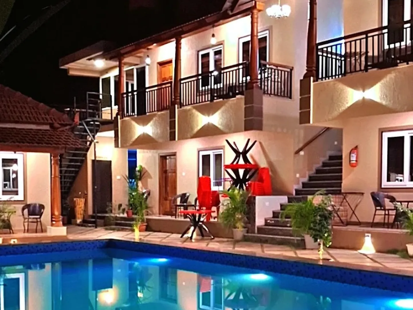 The pool and the balconies above it, lit at night