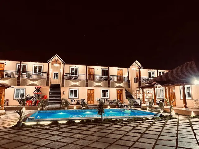The villa pool lit after dark
