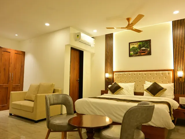 A suite with a sofa, a table and a double bed